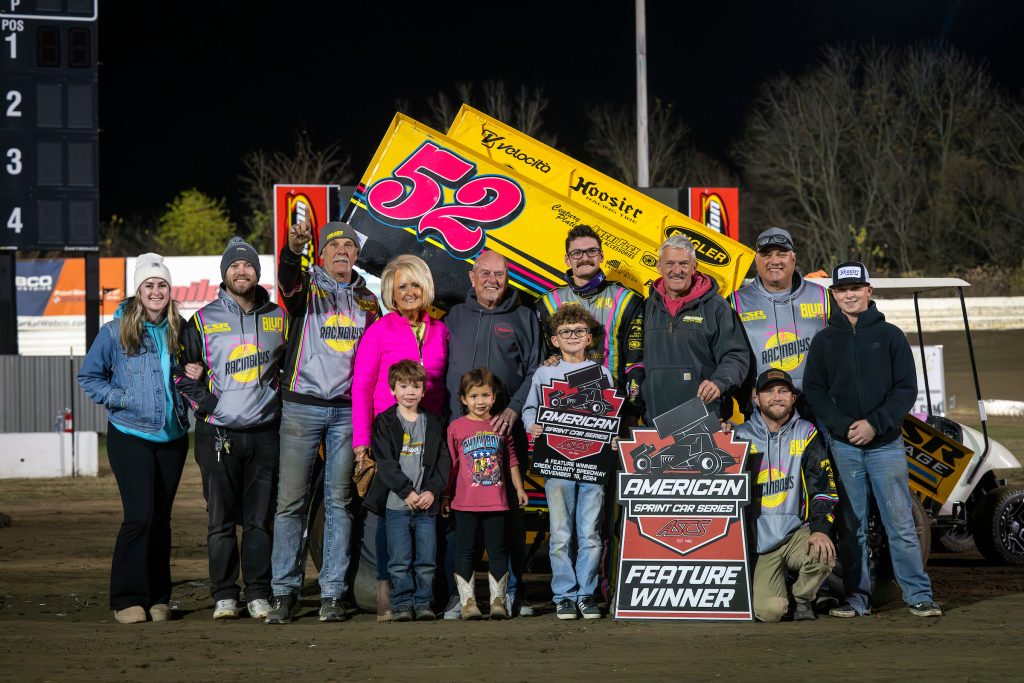 American Sprint Car Series driver Blake Hahn standing with his family and crew in Victory Lane at Creek County Speedway.